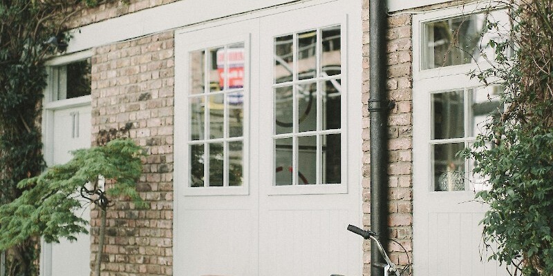 Black Bicycle Parked Beside White Wooden Chair